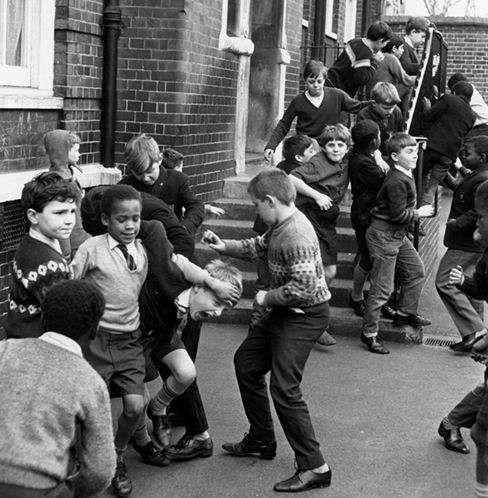 Schoolyard overflowing with boys.