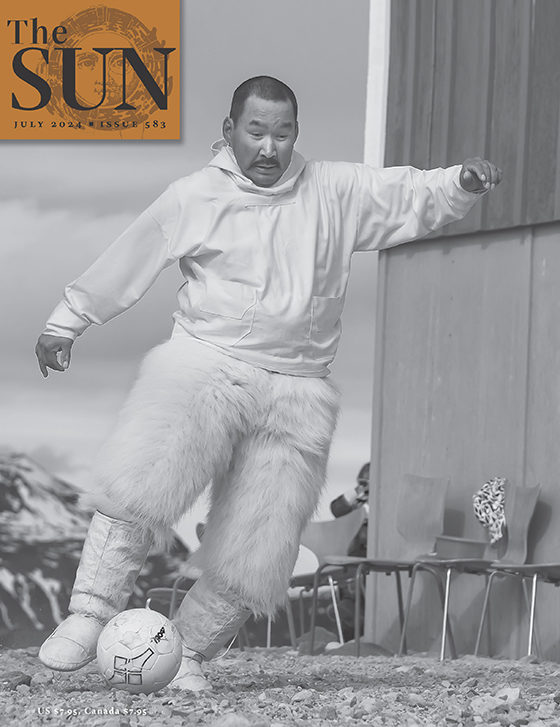 July 2024 cover of The Sun. Subsistence hunter Peter Avike, dressed in Greenland’s traditional costume of sealskin boots and trousers made from polar-bear skin, plus a white hoodie, plays soccer in Siorapaluk on Greenland’s National Day in 2013.