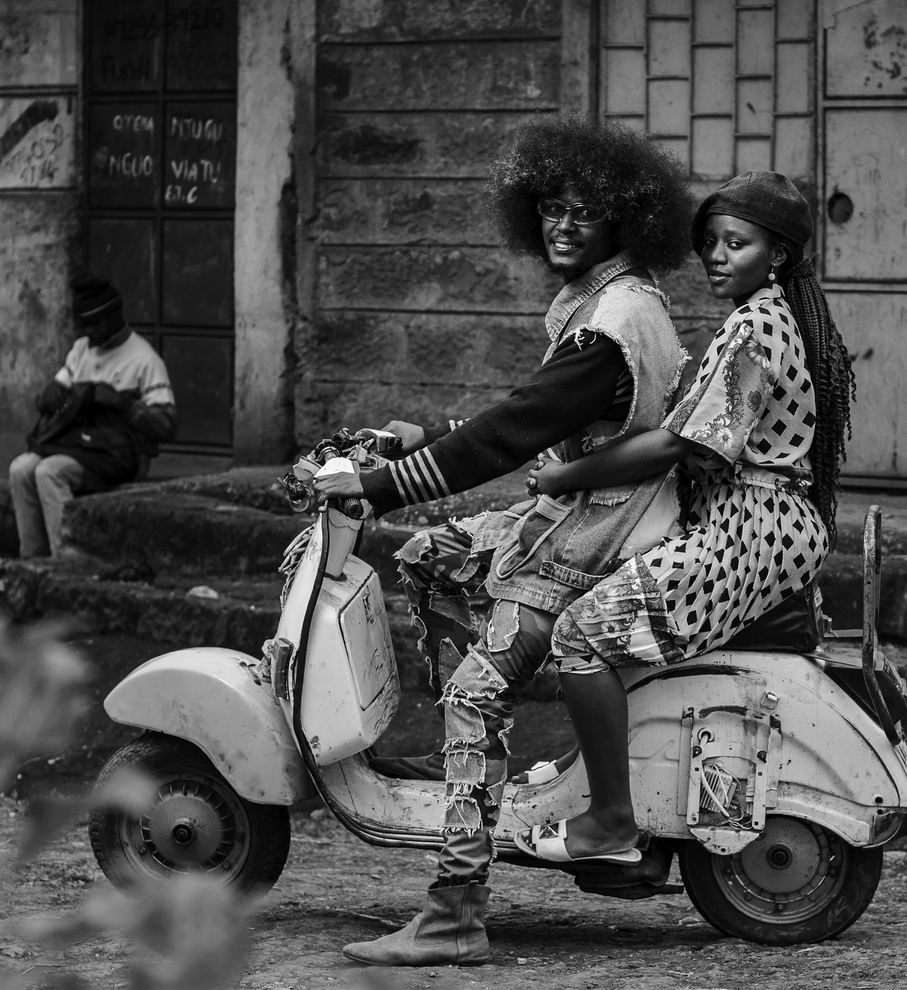 A young man and woman on a scooter in Cianda, Kiambu, Kenya.