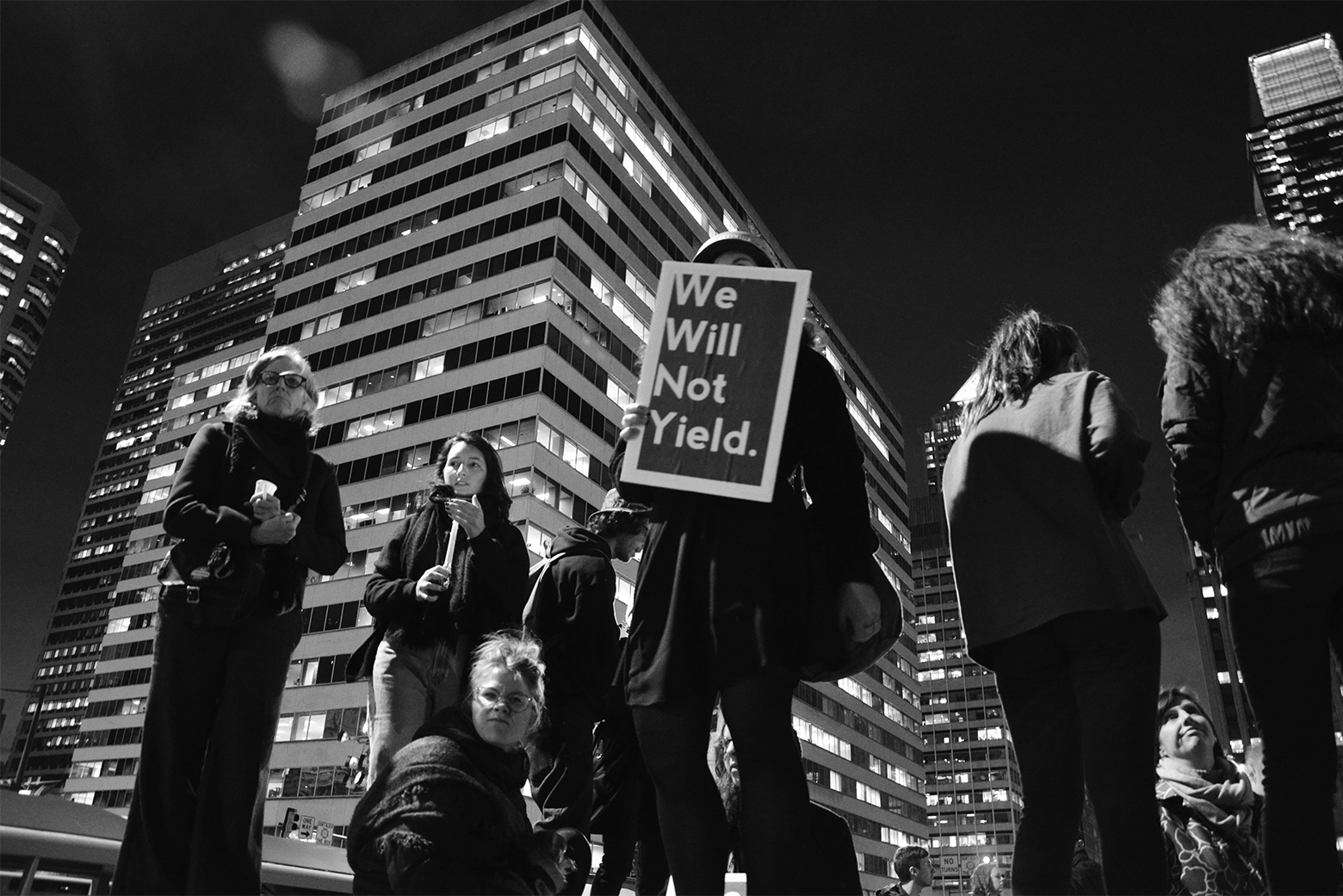 A group of protesters at an anti-Trump demonstration in Philadelphia in 2016. One of the protesters holds a sign that reads, We Will Not Yield.