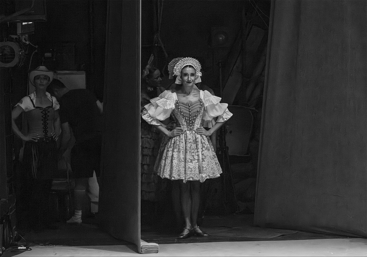 Dancers in costume wait backstage for their cue.