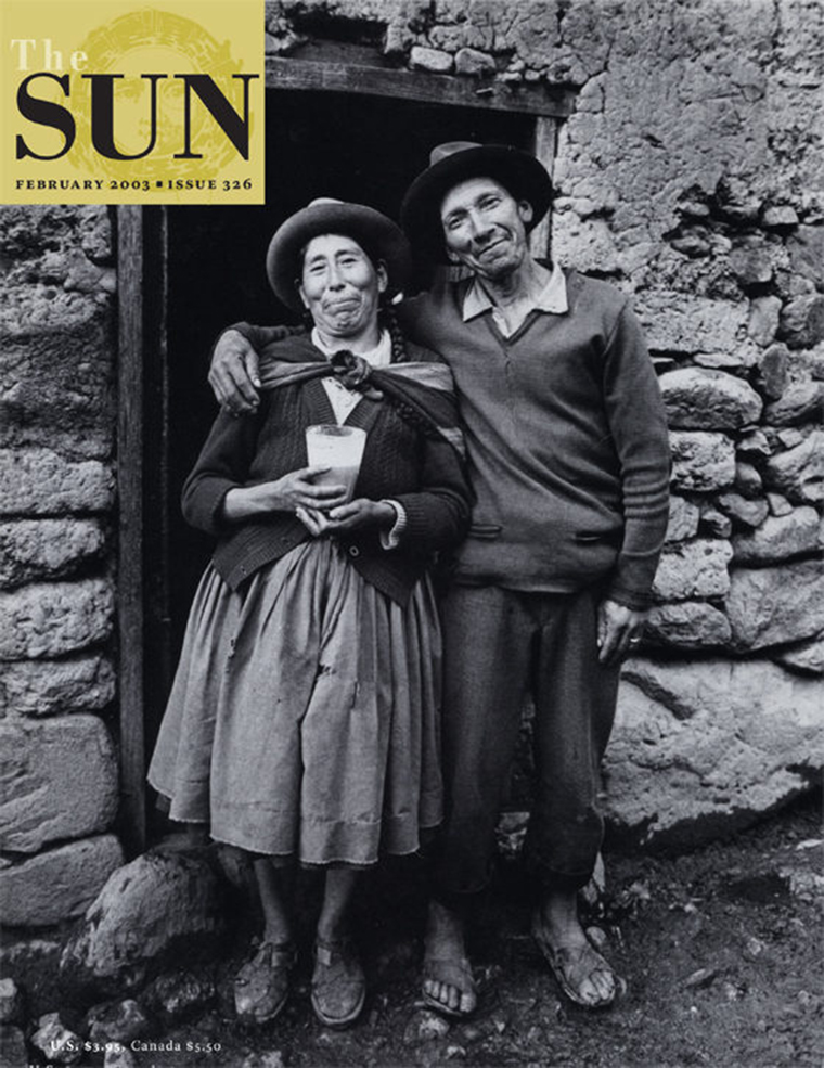 February 2003 cover of The Sun. A slightly inebriated, smiling couple stand together outside in front of a doorway in Ollantaytambo, the last continuously inhabited Inca village in Peru. The man has his arm around the shoulders of the woman.