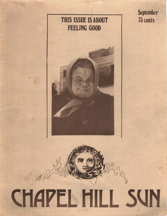 September 1975 cover of The Sun. The scowling face of an old woman in a headscarf is underneath text that reads “This issue is about feeling good.” This cover is the first appearance of the sun-with-a-monocle logo on the front cover.