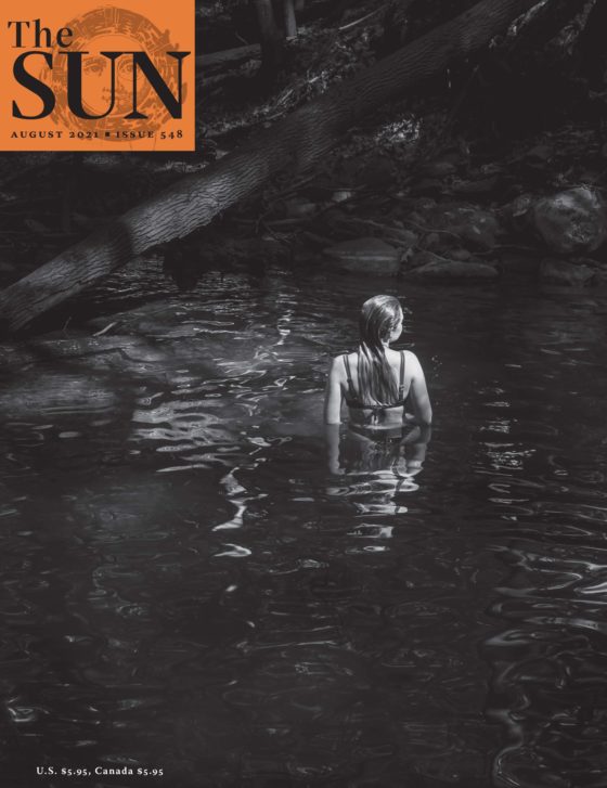 The photographer’s daughter in a swimming hole at Slateford Creek Falls in Pennsylvania. The daughter has her back turned to the camera and she’s looking slightly to the right.